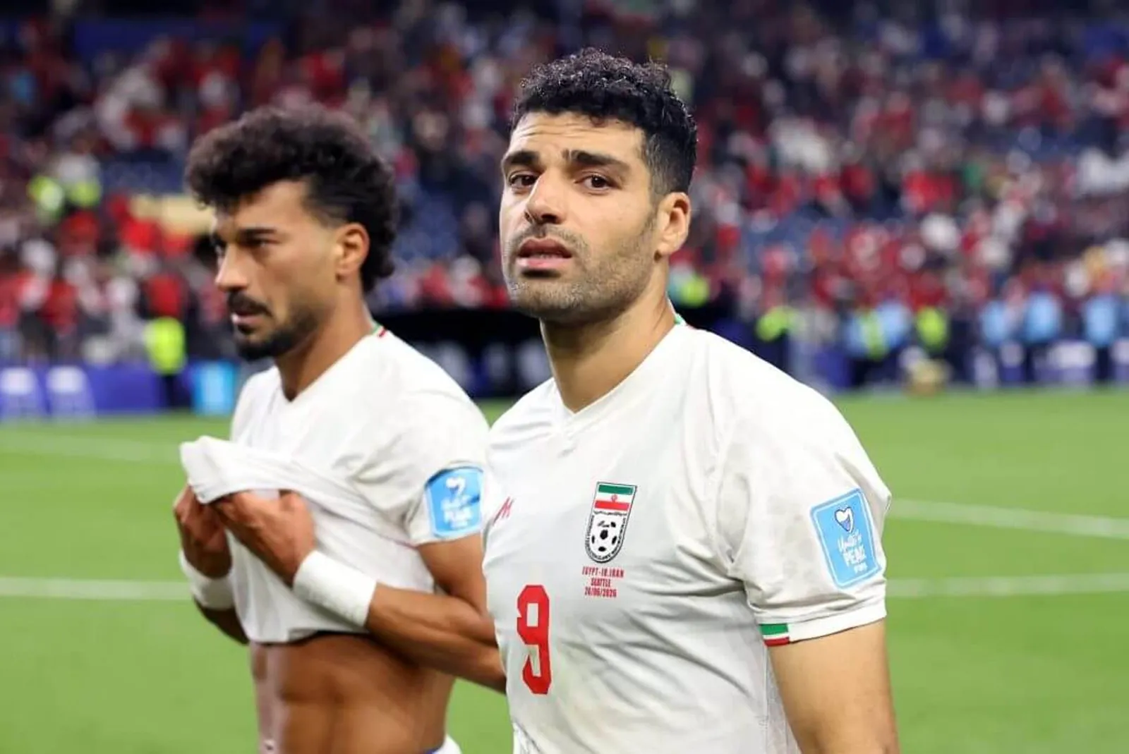 Ramin Rezaeian and Mehdi Taremi of Iran react after the 1-1 draw with Egypt in the World Cup